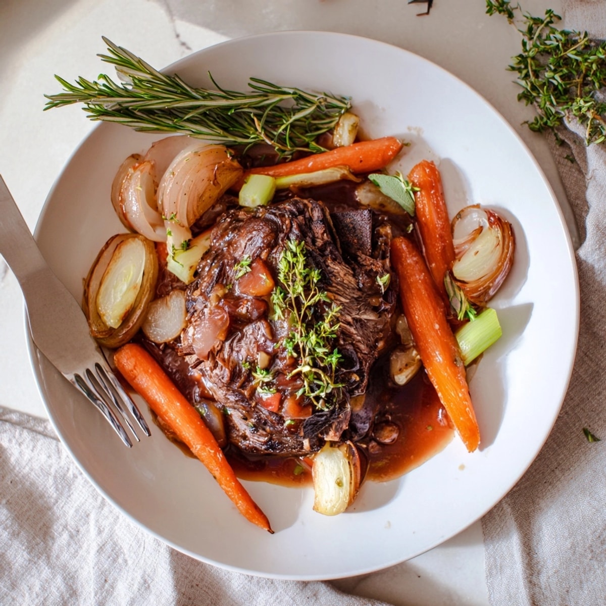 Close-up of glistening Apple Cider Braised Short Ribs, ready to serve with creamy polenta.