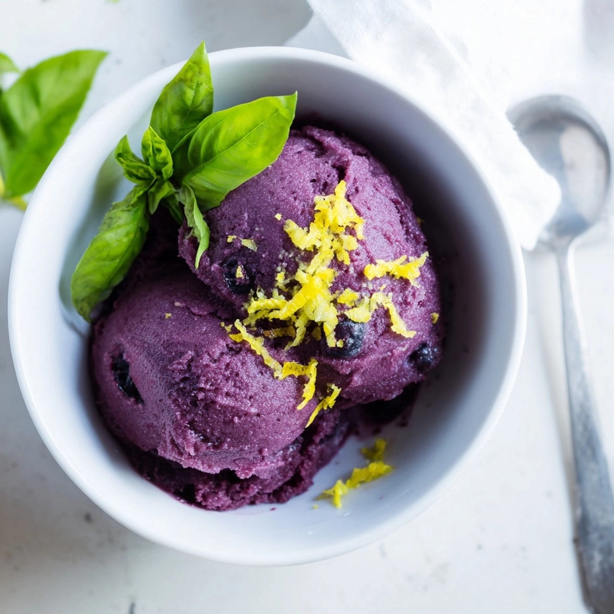 Homemade Blueberry &amp; Basil Lemonade Sorbet, a sweet, tart, and herb-infused frozen treat.