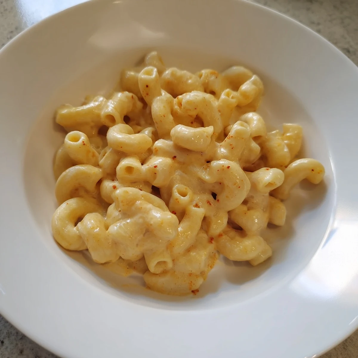 Warm, creamy macaroni and cheese, swimming in a rich cheese sauce and ready to eat.