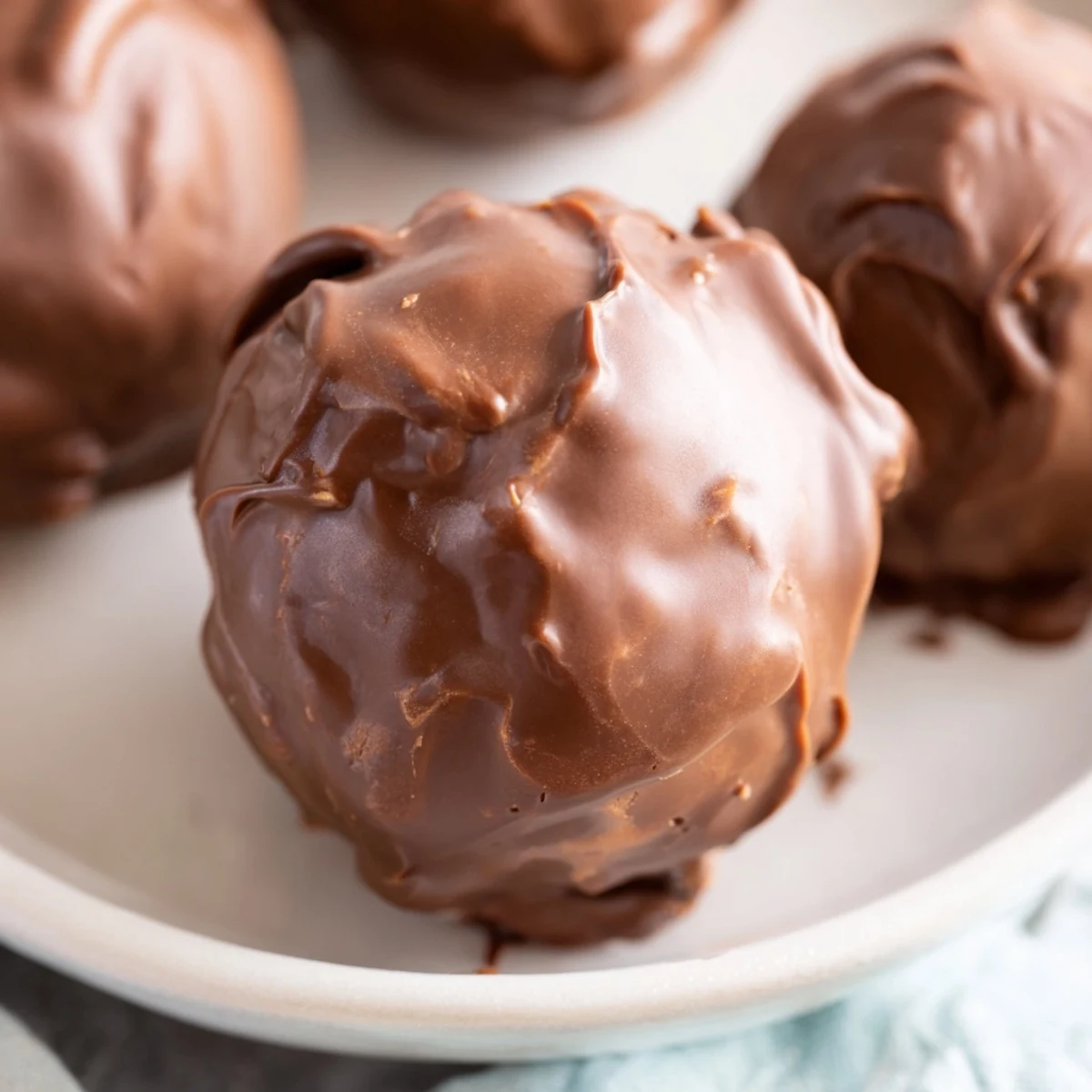 A close-up of perfectly formed Chocolate Peanut Butter Balls, ready to be enjoyed as a sweet treat.
