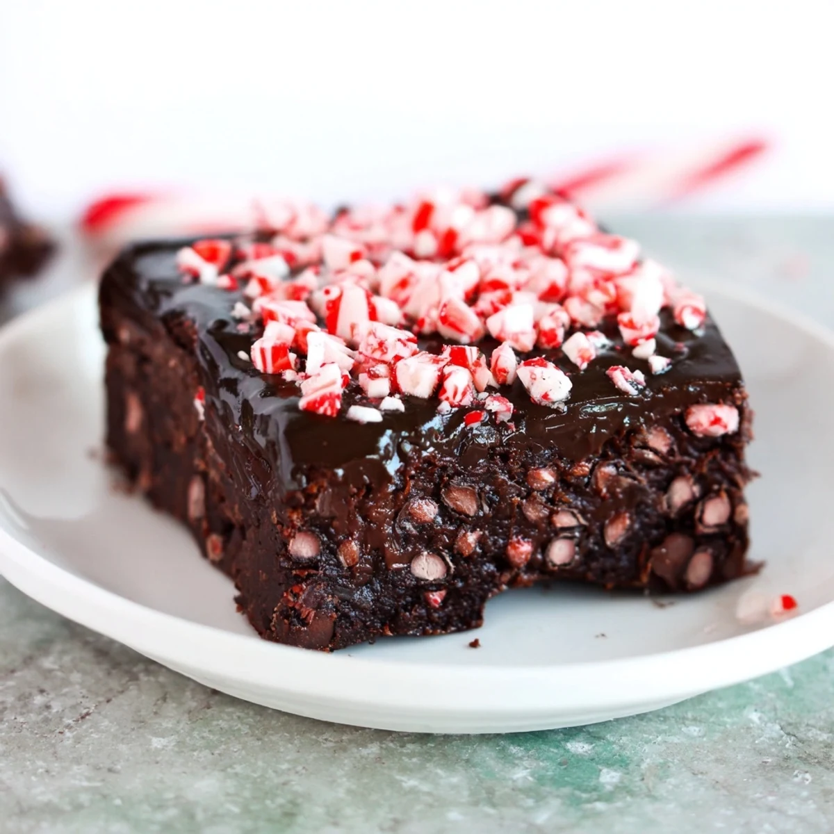 Warm, freshly baked Peppermint Mocha Fudge Brownies topped with glossy chocolate and crushed peppermint.