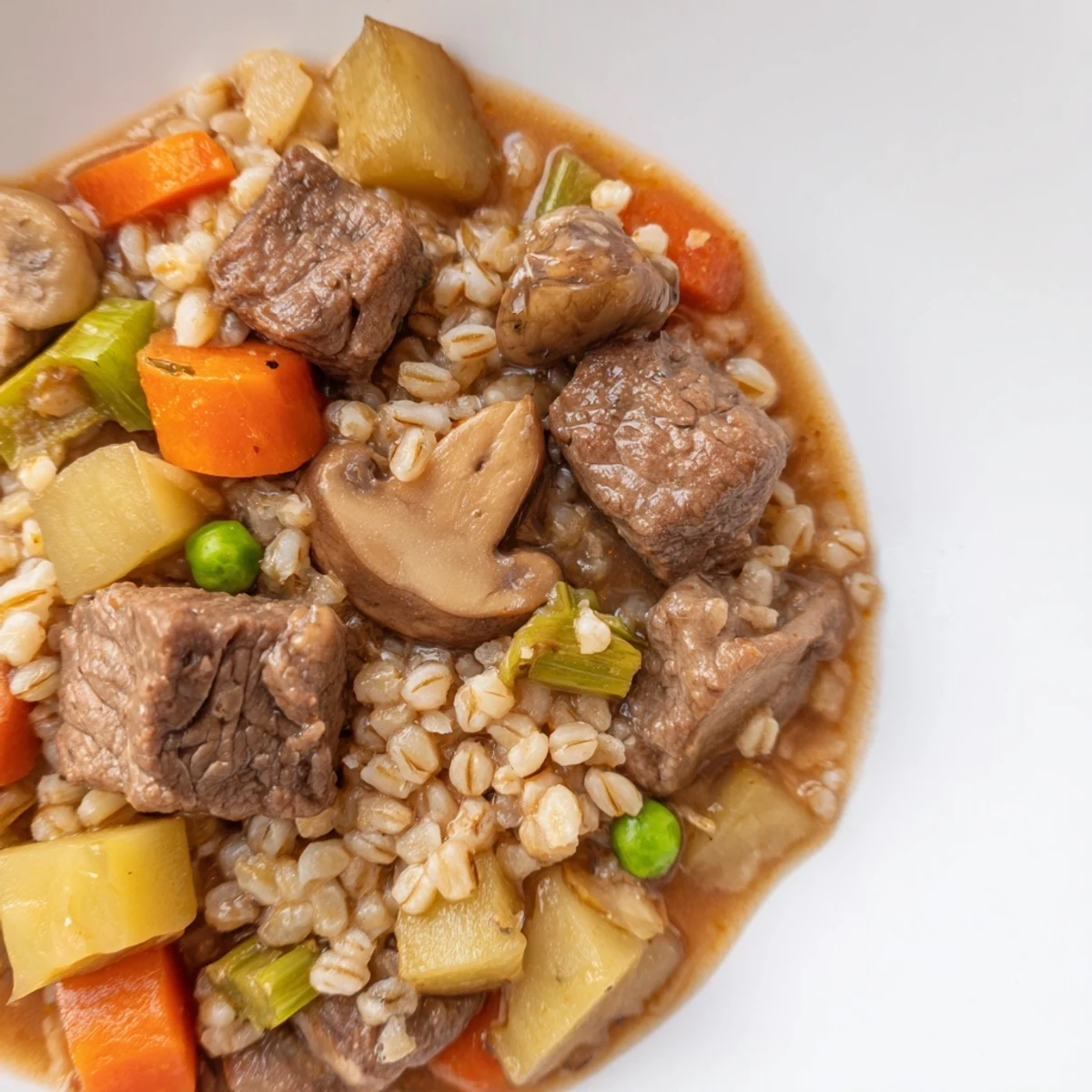 Hearty Beef and Barley Stew: a rustic still life showcasing a warm, comforting bowl with crusty bread for a chilly evening.