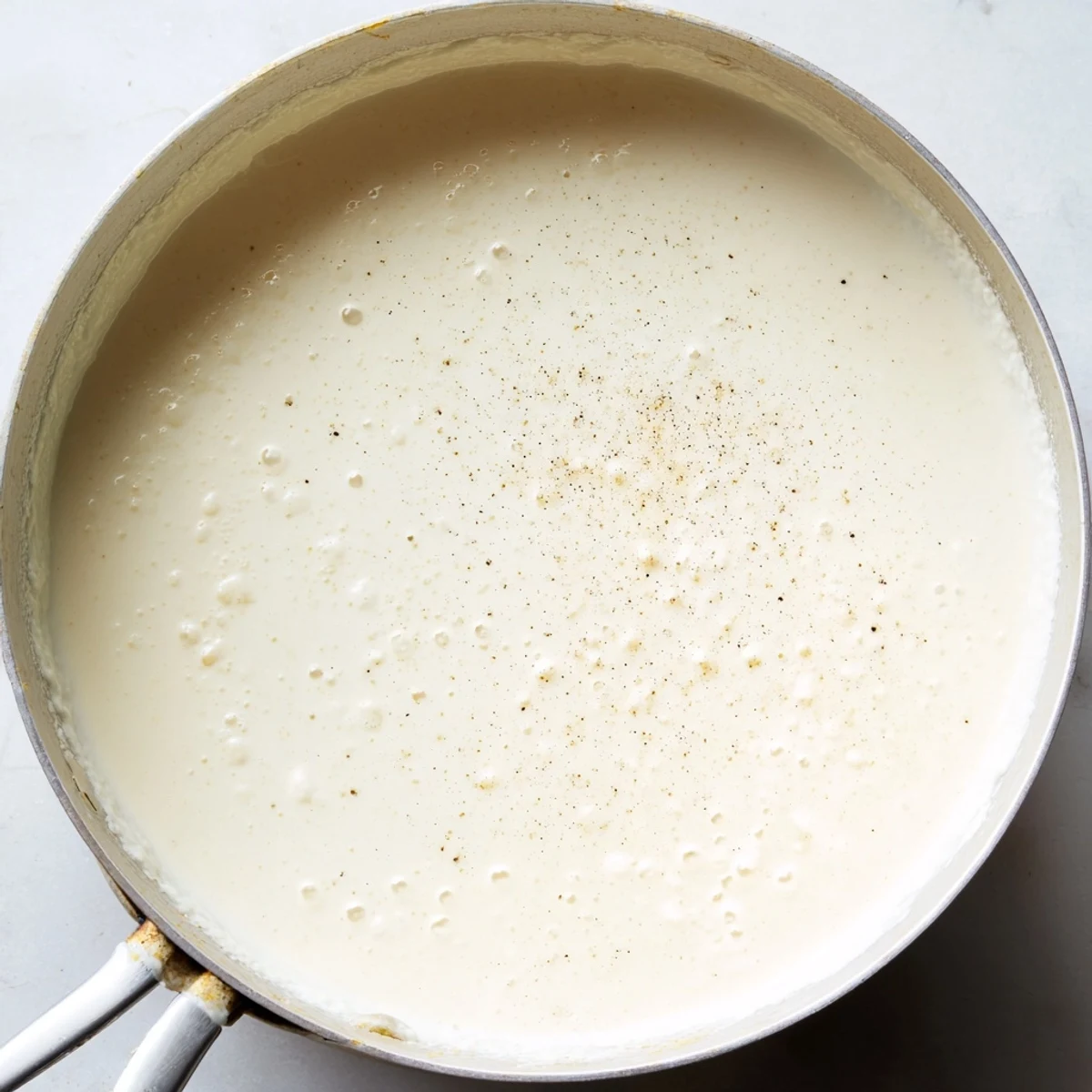 A luscious, creamy sauce base simmering in a pan, ready to add to your favorite dishes.