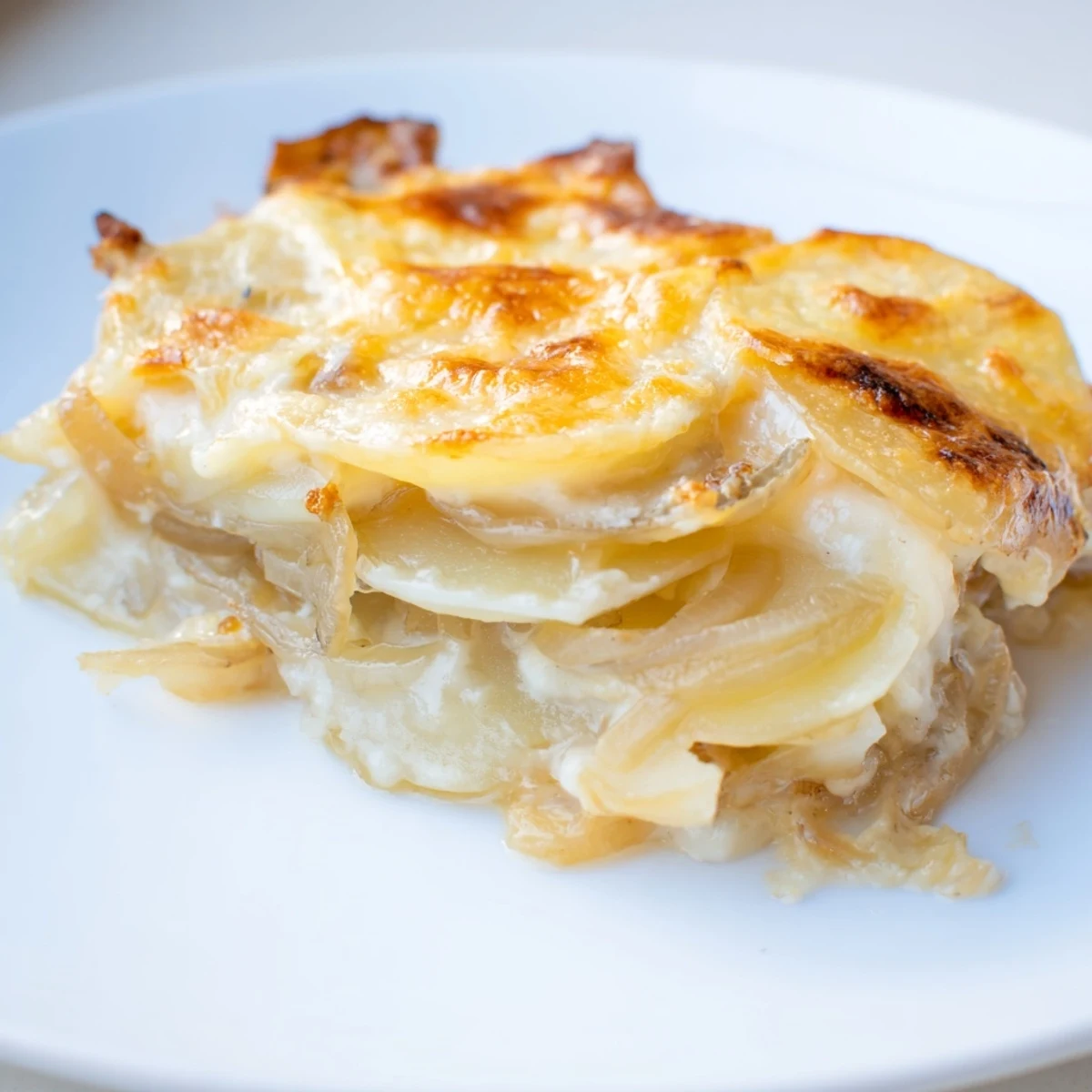 Creamy Scalloped Potatoes baked until tender, featuring layers of potatoes and melted cheese, so delicious.
