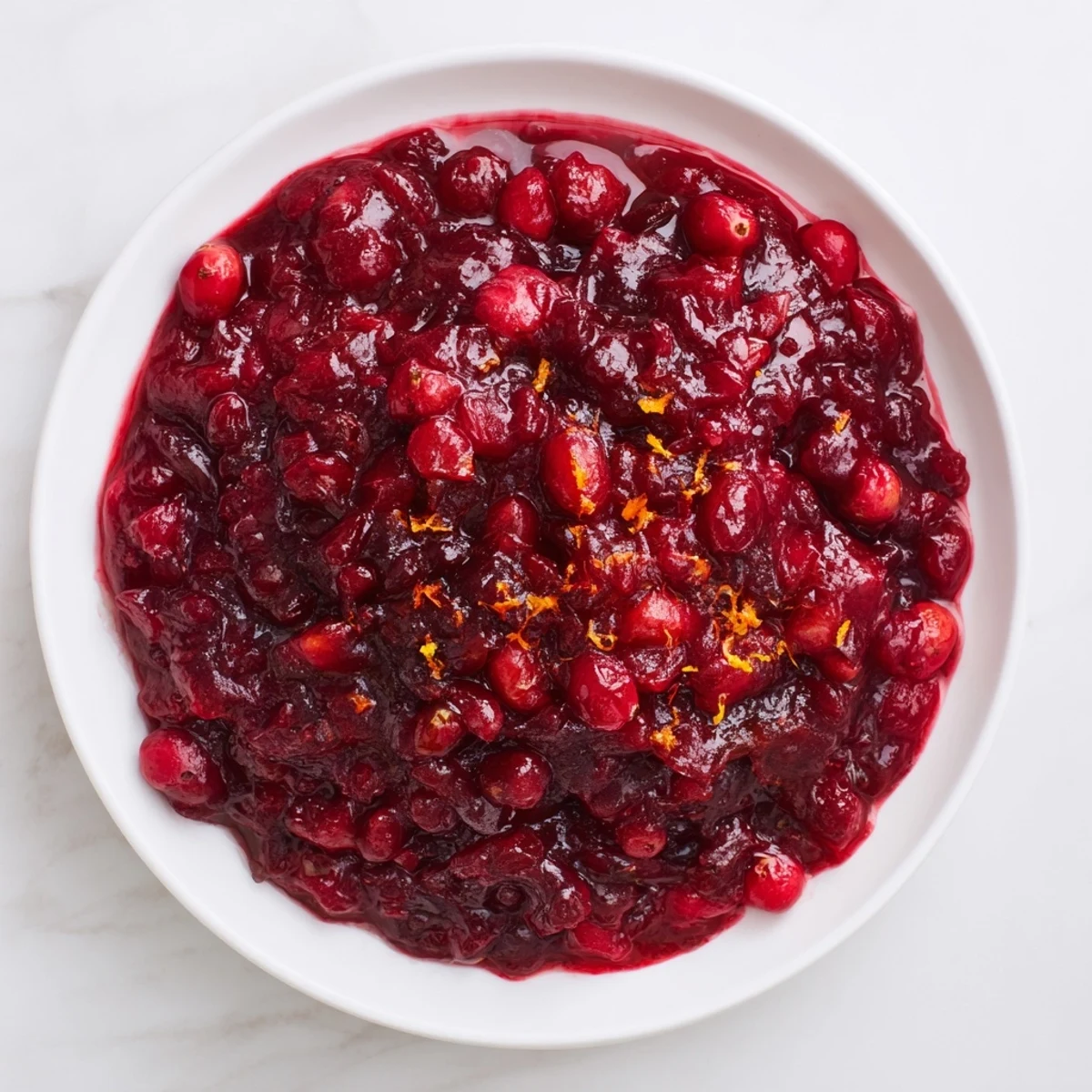 Vibrant red Fresh Cranberry Sauce: Bursting cranberries simmered with warm spices, ready to spoon.