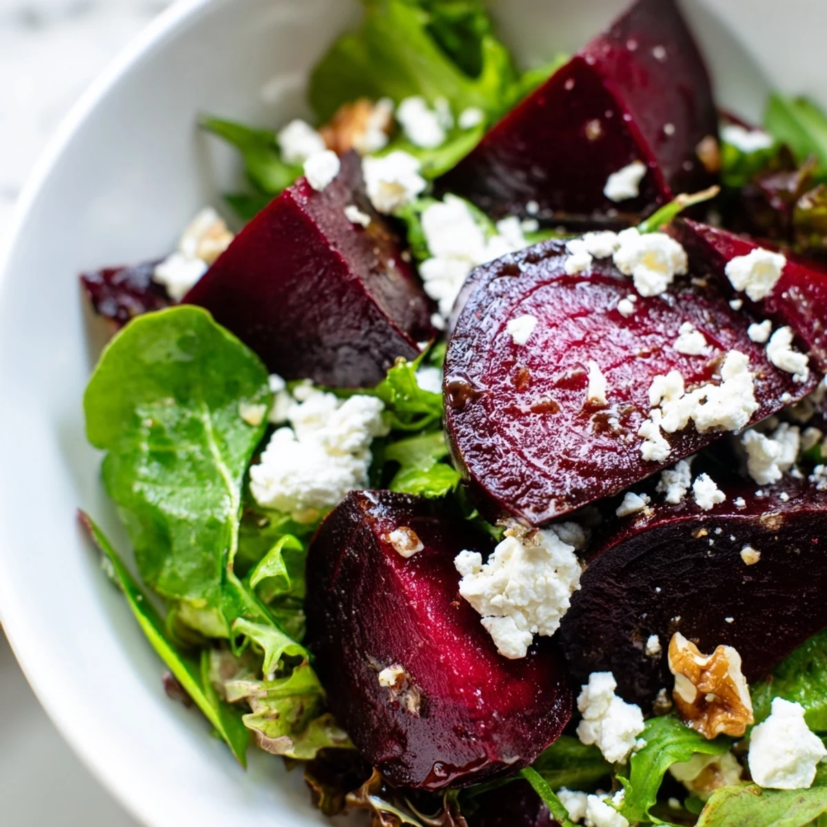 This roasted beet salad features tender beets complemented by tangy balsamic vinaigrette and a sprinkle of nuts.