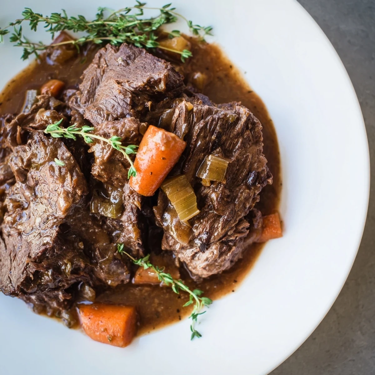 Tender, fall-apart Braised Beef served with a rich, dark sauce perfect for spooning over mashed potatoes.