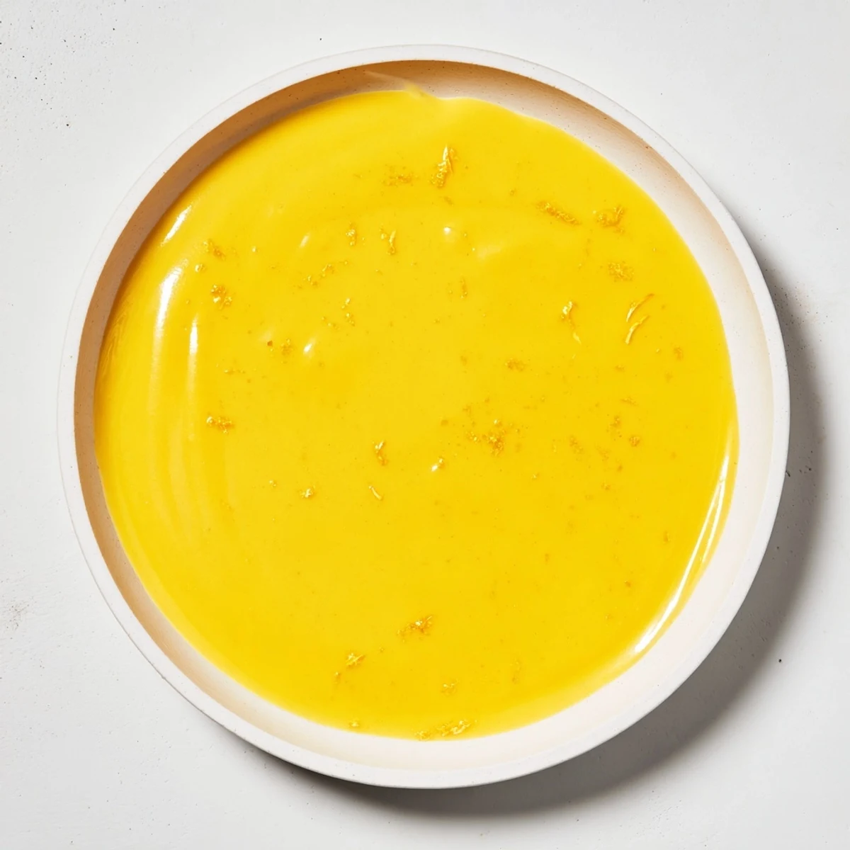Bright yellow Zesty Lemon Curd, smooth and glossy, perfect for slathering on warm scones.