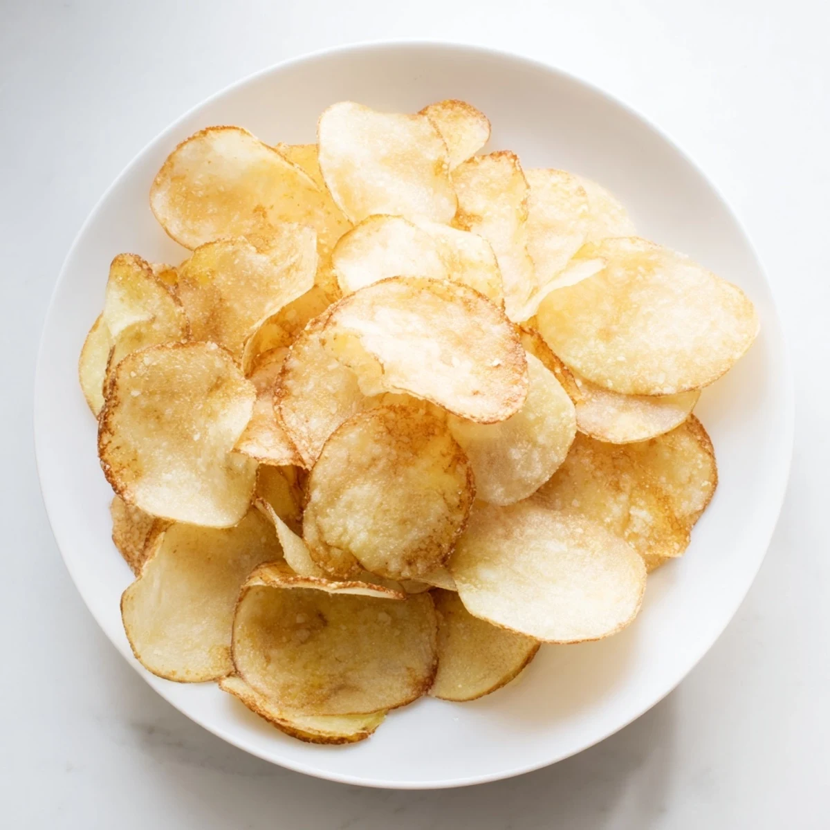 Crunchy golden chips, freshly fried and seasoned, perfect for a savory snack.