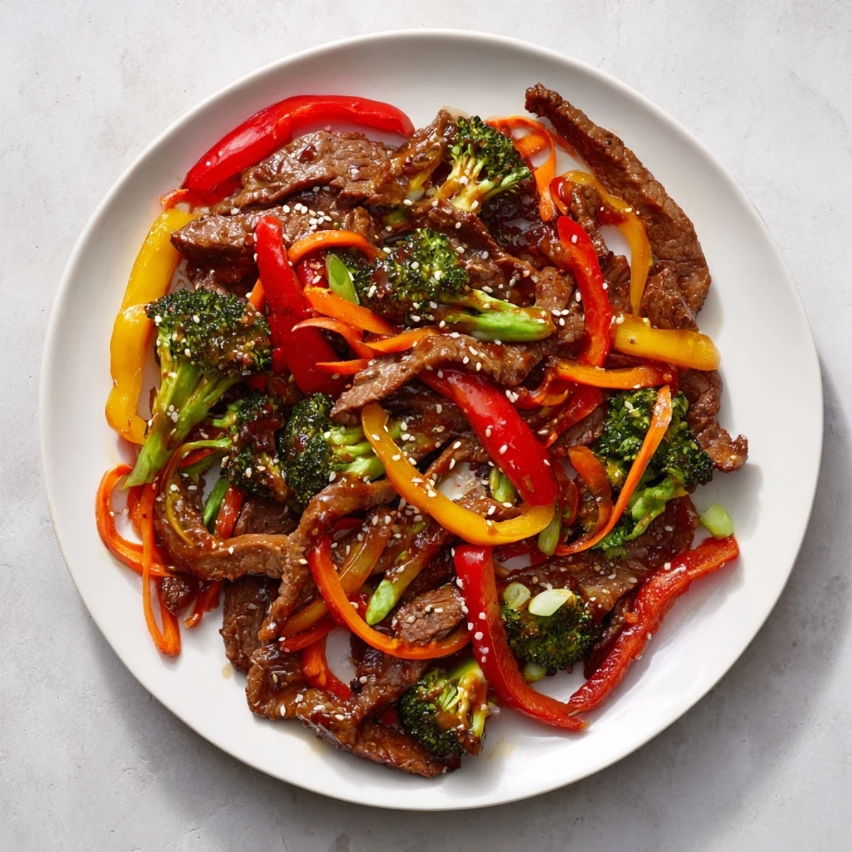 A steaming bowl of beef stir fry, with perfectly cooked beef and vibrant, crunchy bell peppers.