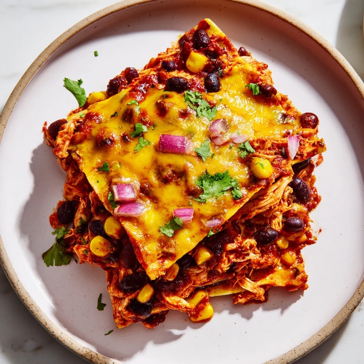 Golden, bubbly Chicken Enchilada Casserole with melted cheese, ready to serve with fresh garnishes.