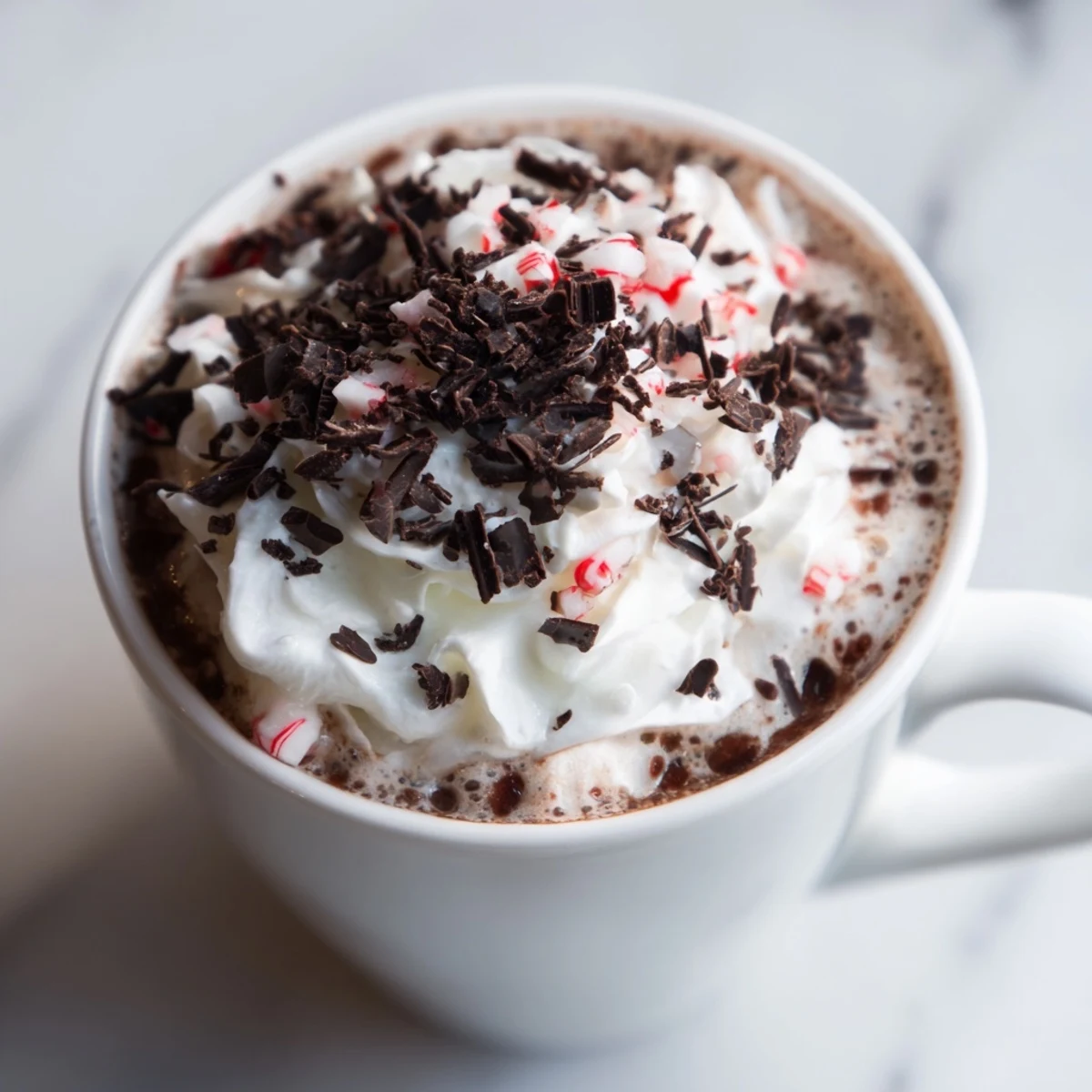 Steamed whole milk and espresso mingle with rich chocolate in a mug for this Peppermint Mocha. Topped with whipped cream and crushed peppermint candy canes.