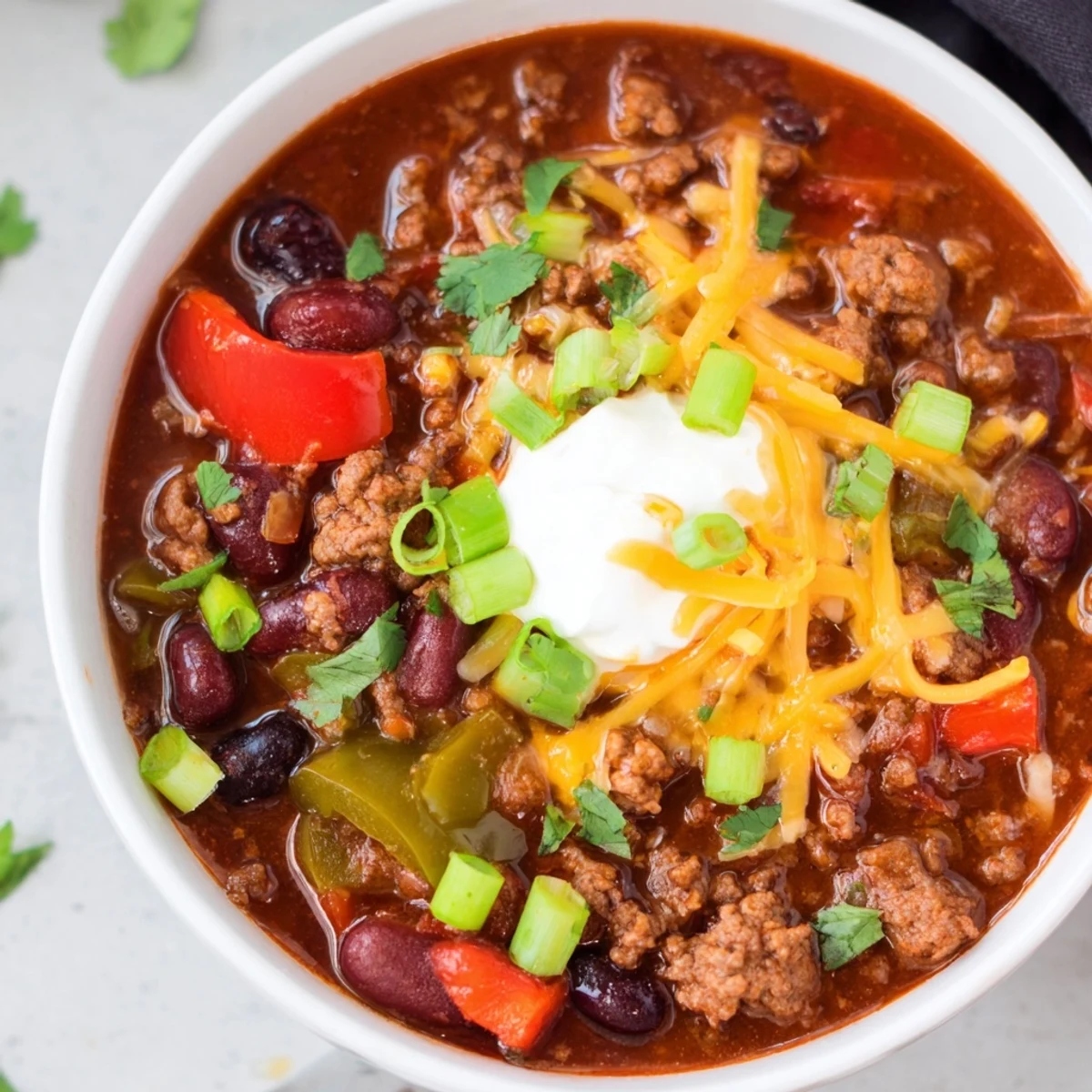 Steamy Slow Cooker Chili with Ground Beef bubbles in a black slow cooker, rich red sauce with tender beans and peppers.