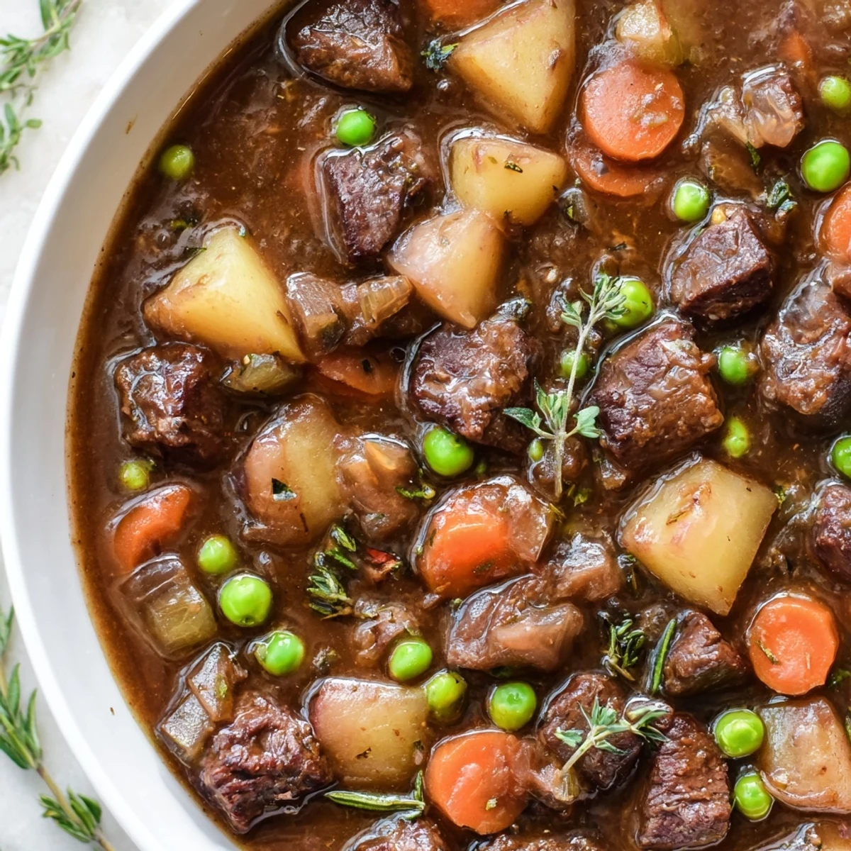Close-up view of Slow Cooker Beef and Vegetable Stew, highlighting the melt-in-your-mouth beef and vibrant vegetables in a thick, savory gravy, ready for a comforting meal.