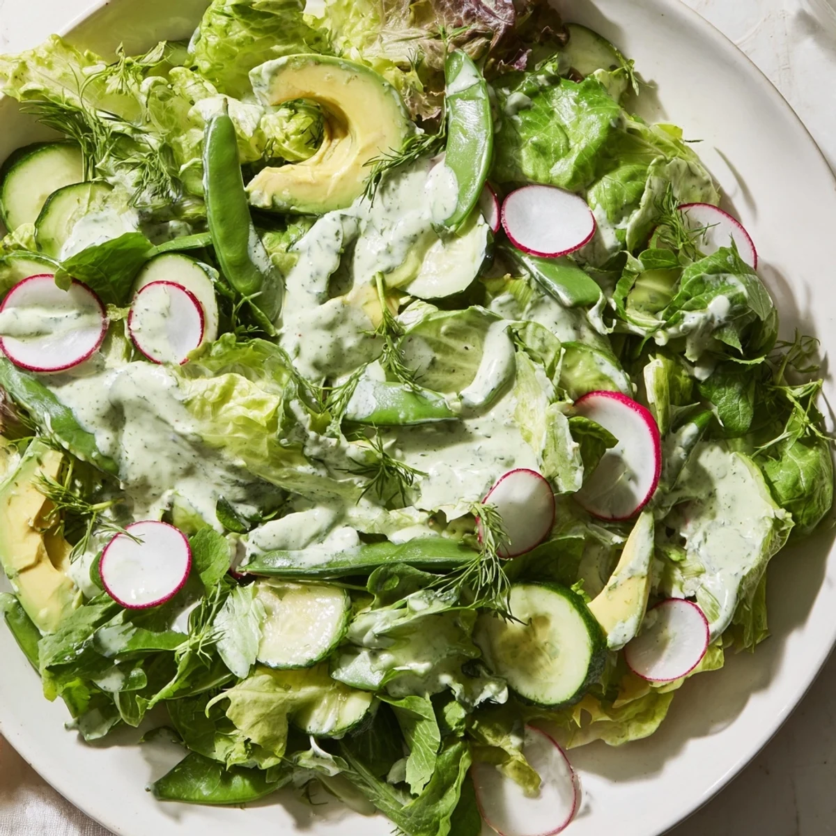 A bright, herb-packed green salad with sugar snap peas and radishes for crunch.