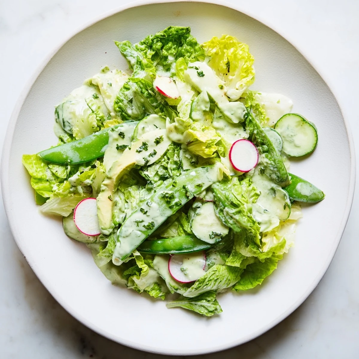 Close-up of a colorful Green Salad featuring radishes and creamy dressing, perfect for a quick, refreshing vegetarian lunch.