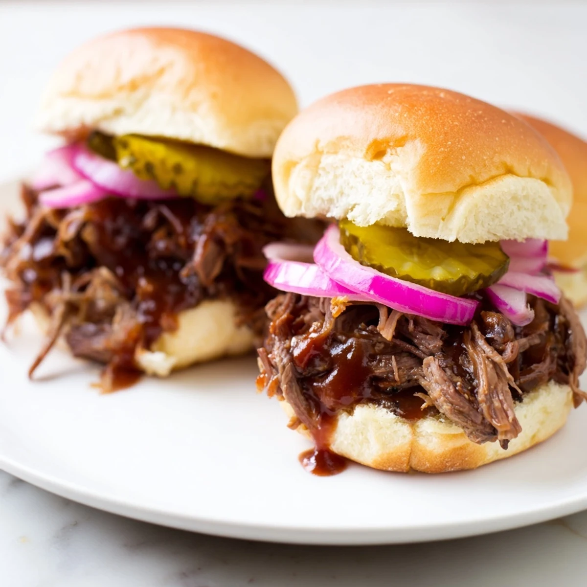 Tender shredded beef sliders with tangy pickles and onions, served warm on buttery toasted buns for game day.