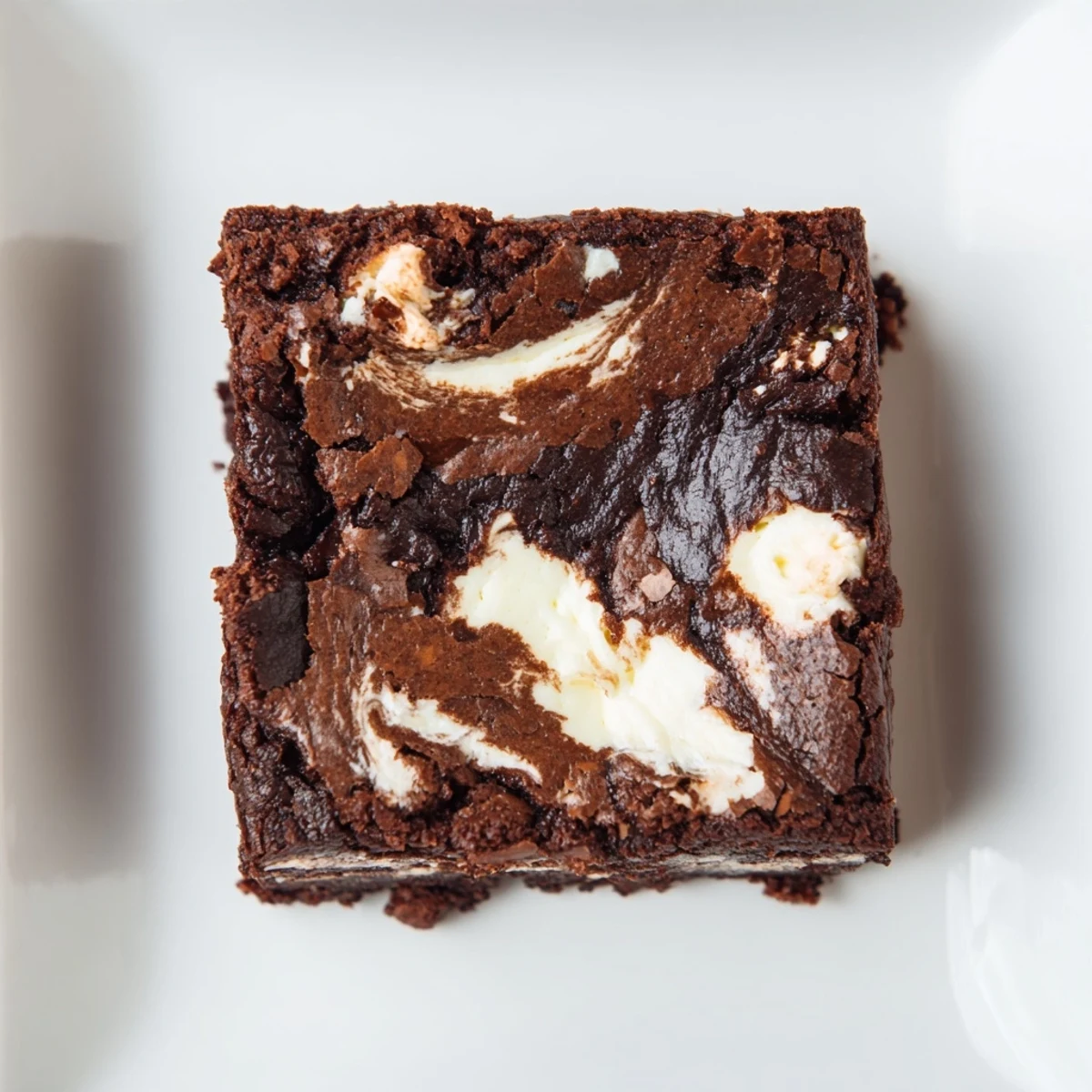 Slice of Cottage Cheese Brownies topped with a dollop of whipped cream and fresh raspberries.