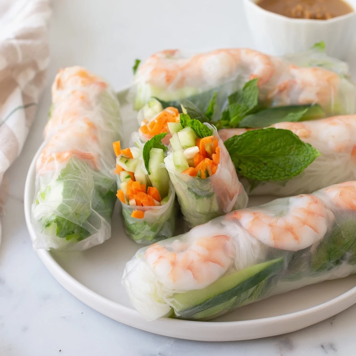 Vietnamese Spring Rolls with vibrant carrots, cucumbers, and shrimp, wrapped in soft rice paper, ideal for a light appetizer.