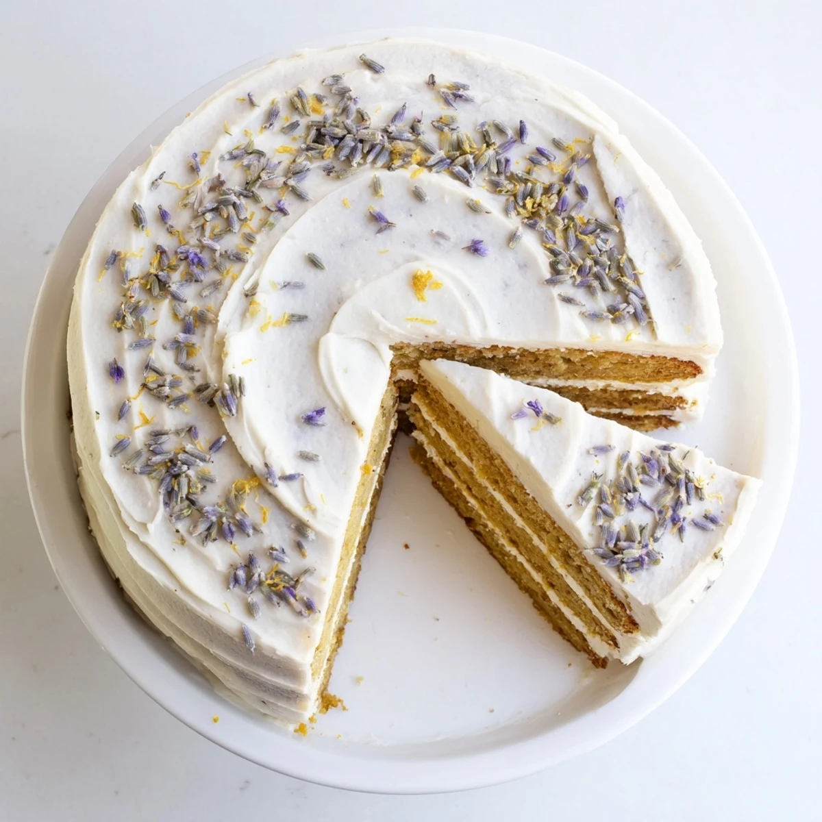 A close-up view of London Fog Cake with Earl Grey & Lavender, showing moist tea-infused layers and a rustic slice ready to serve.