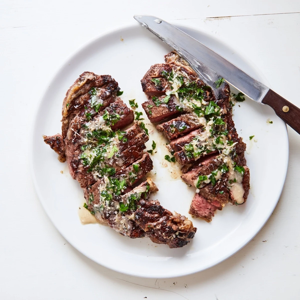 Juicy Steak With Creamy Garlic Sauce served with roasted potatoes and fresh parsley garnish.