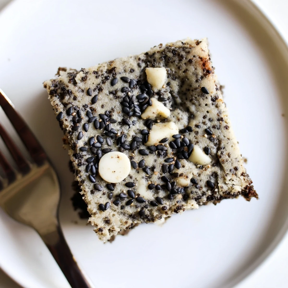 Golden-brown Black Sesame Blondies studded with white chocolate chips, showcasing their fudgy, chewy texture and nutty aroma.