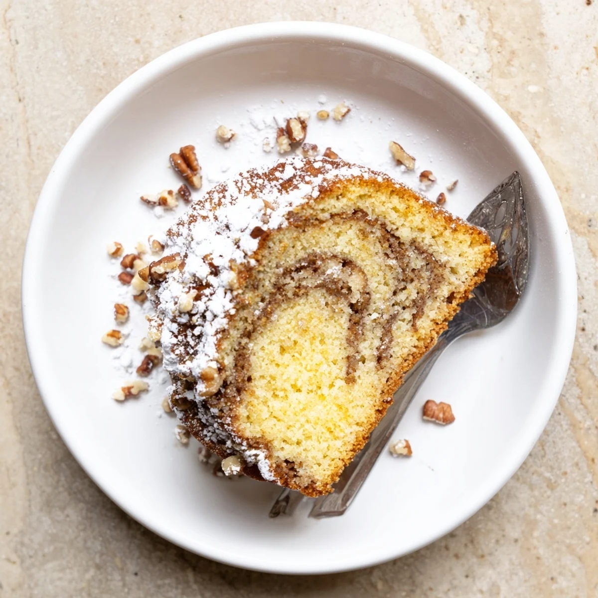 Golden-brown Easy Breakfast Bundt Coffee Cake on a cooling rack, showcasing a moist crumb and sweet cinnamon ribbon inside.