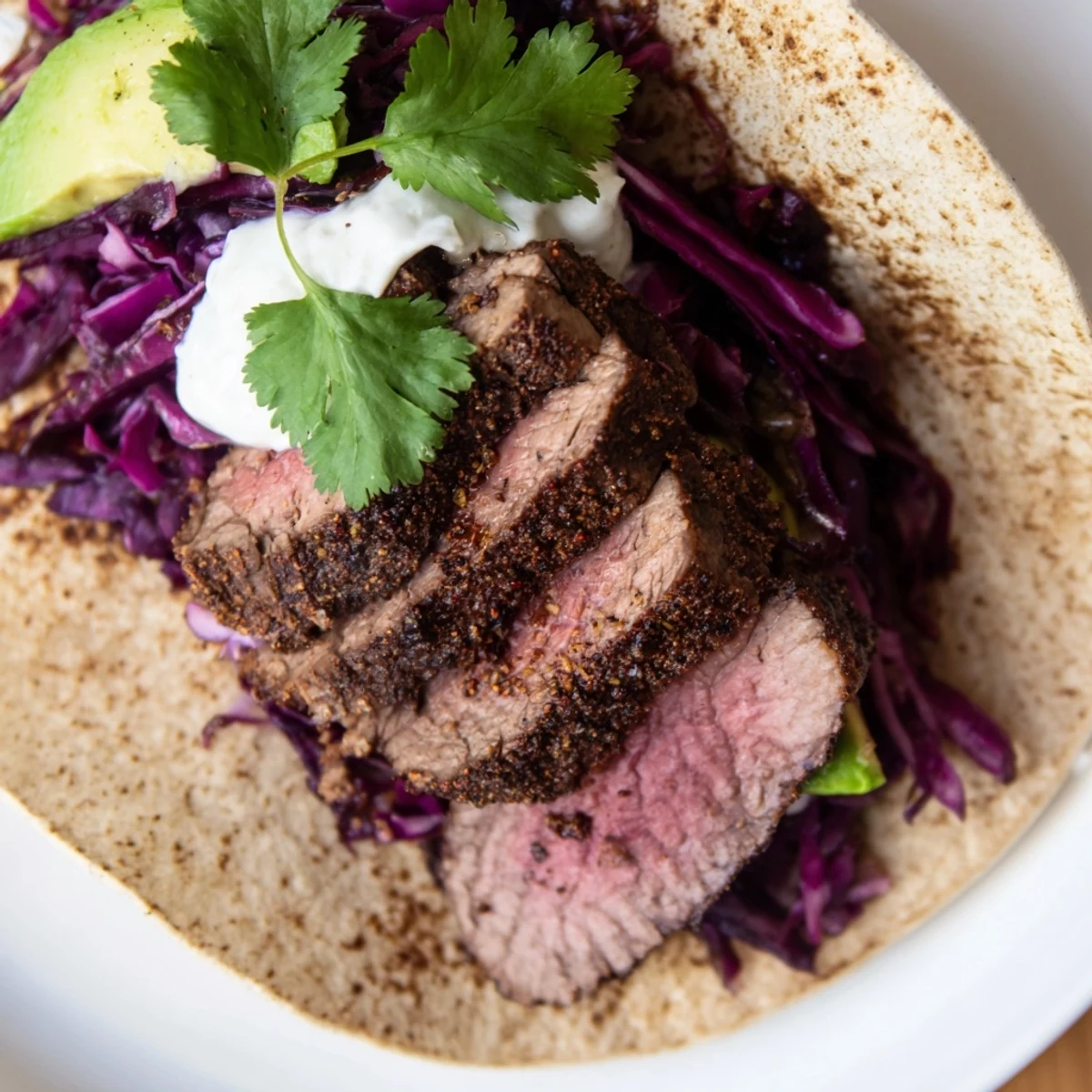 Golden roasted cumin crusted leg of lamb sliced into soft corn tortillas with fresh cilantro