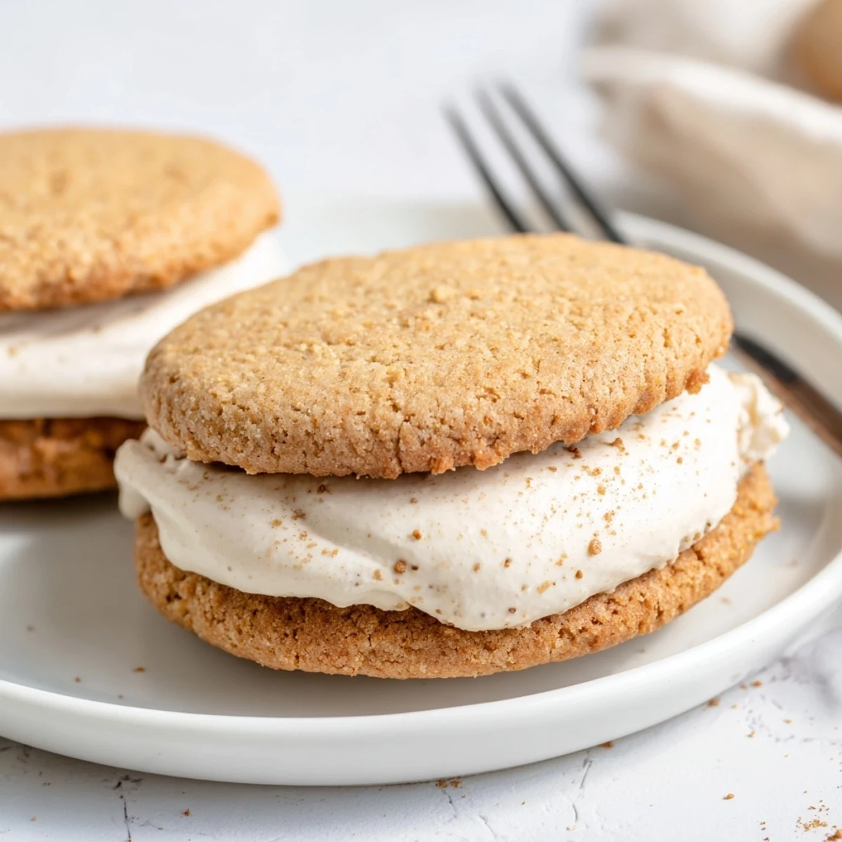 Stack of chai shortbread cookie sandwiches dusted with powdered sugar ready for afternoon tea