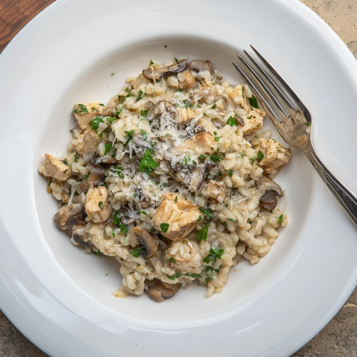 Oven-baked chicken and mushroom risotto serving dish showcasing creamy texture and savory Italian flavors