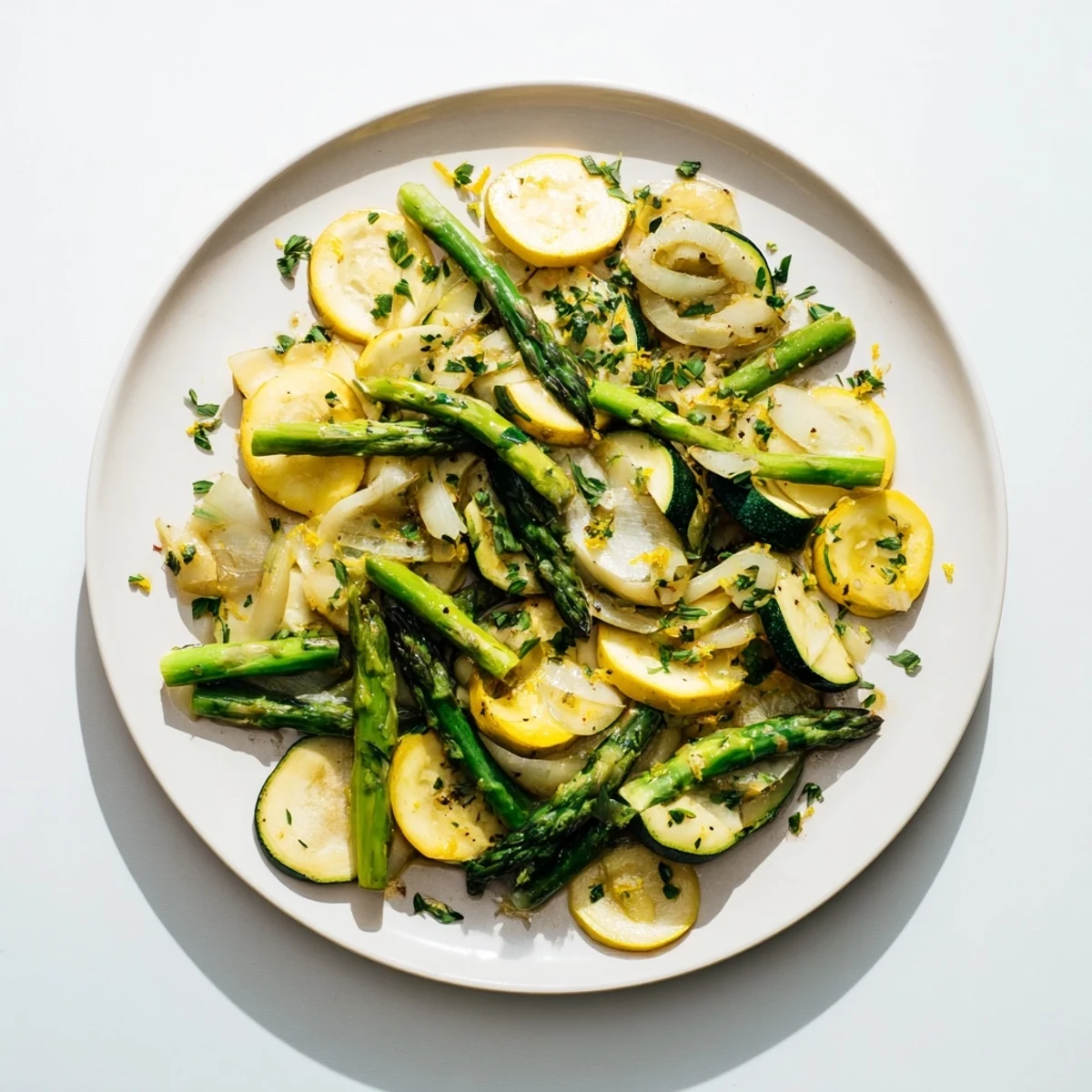 Golden green and yellow seasonal vegetables cooked in olive oil with thyme and garlic for a healthy side dish