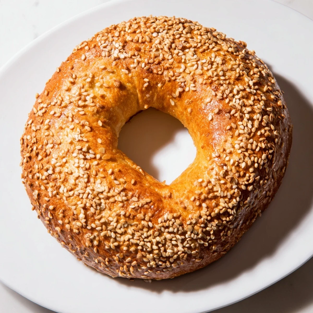 Handheld spinach cottage cheese flagels brushed with egg wash and topped with poppy seeds, ready to serve