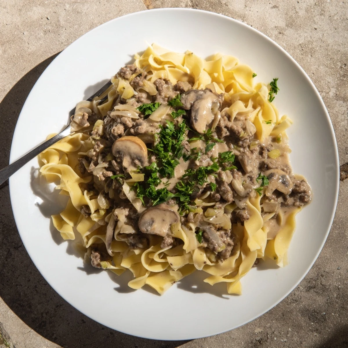 Hearty hamburger stroganoff with sautéed mushrooms and ground beef in creamy white sauce