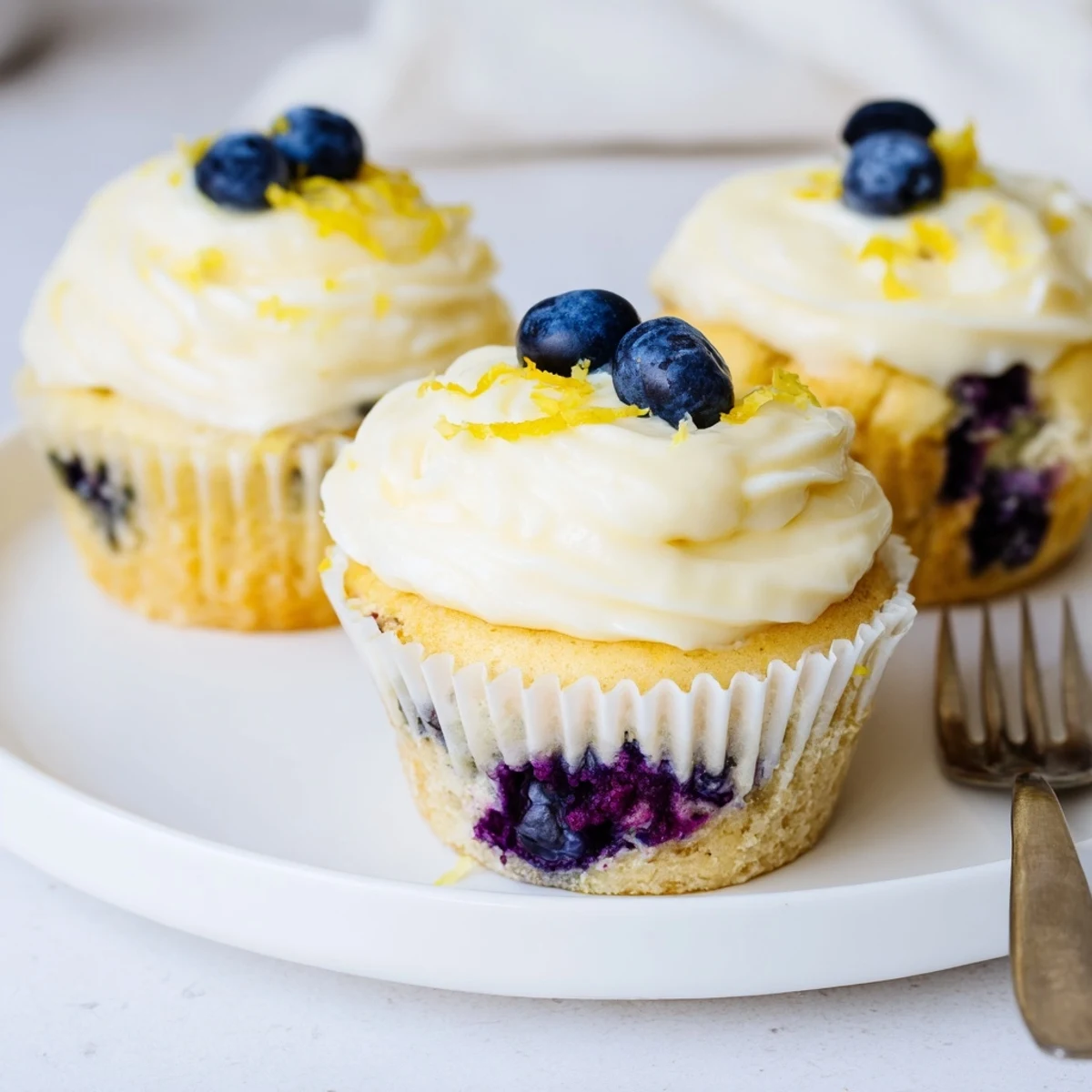 Summer lemon blueberry cupcakes with fluffy yellow crumb, plump berries, and tangy cream cheese topping