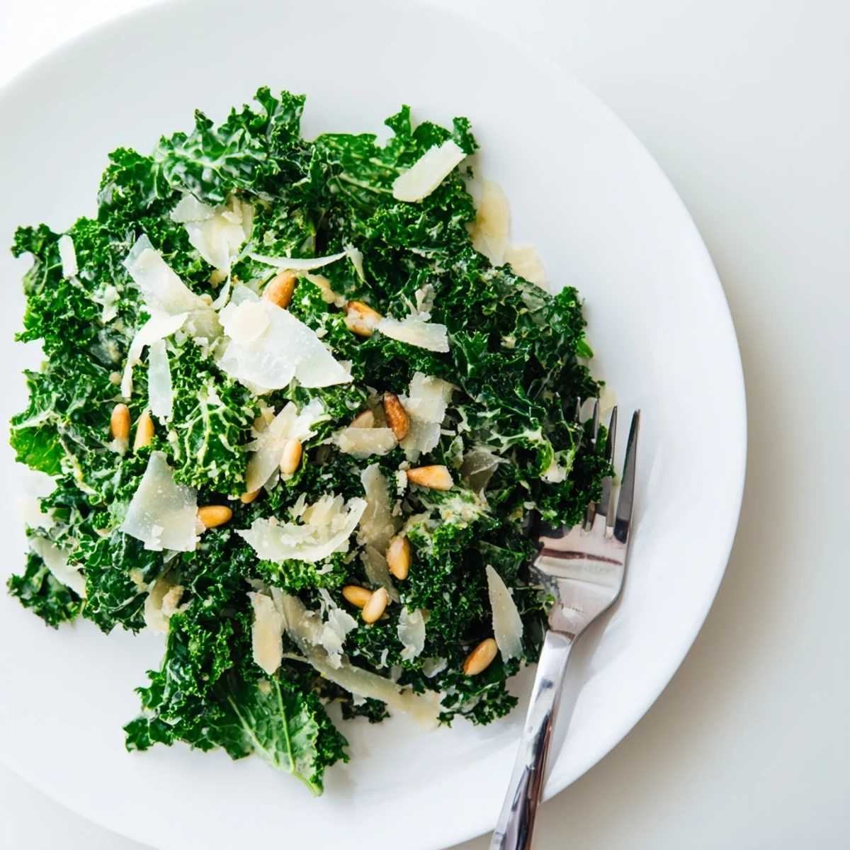 Fresh garlic lemon Parmesan kale salad with glossy dressed leaves and shaved cheese