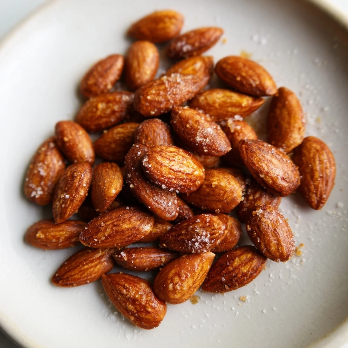 Crunchy smoked paprika roasted almonds piled in a shallow serving dish