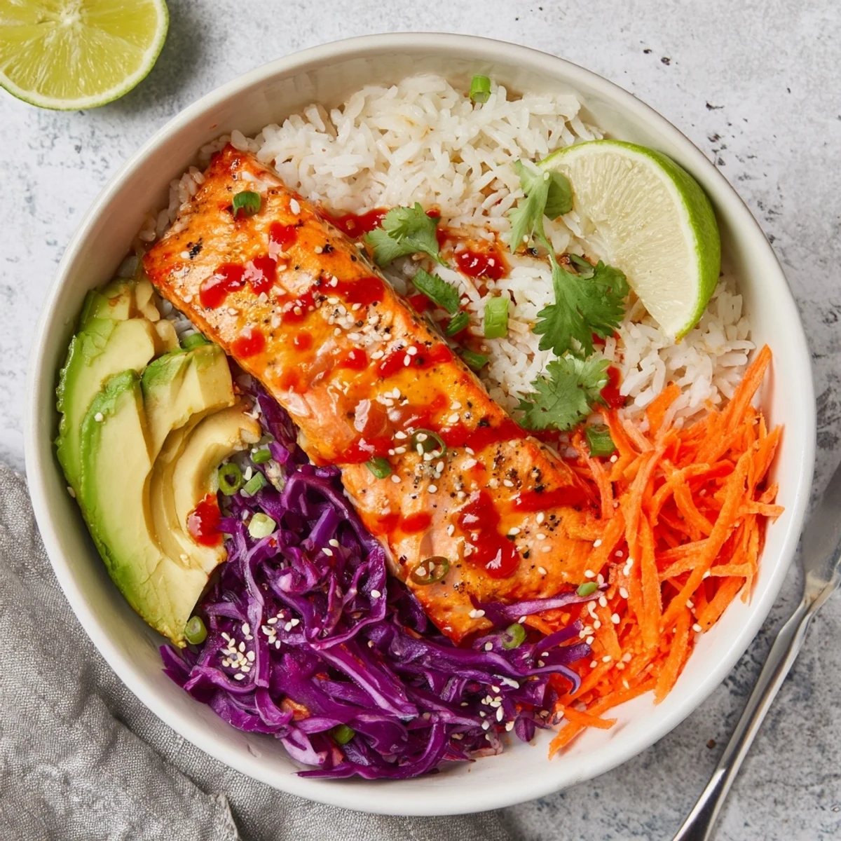 Warm Bang Bang Salmon Bowls on jasmine rice, crunchy cabbage, lime wedge