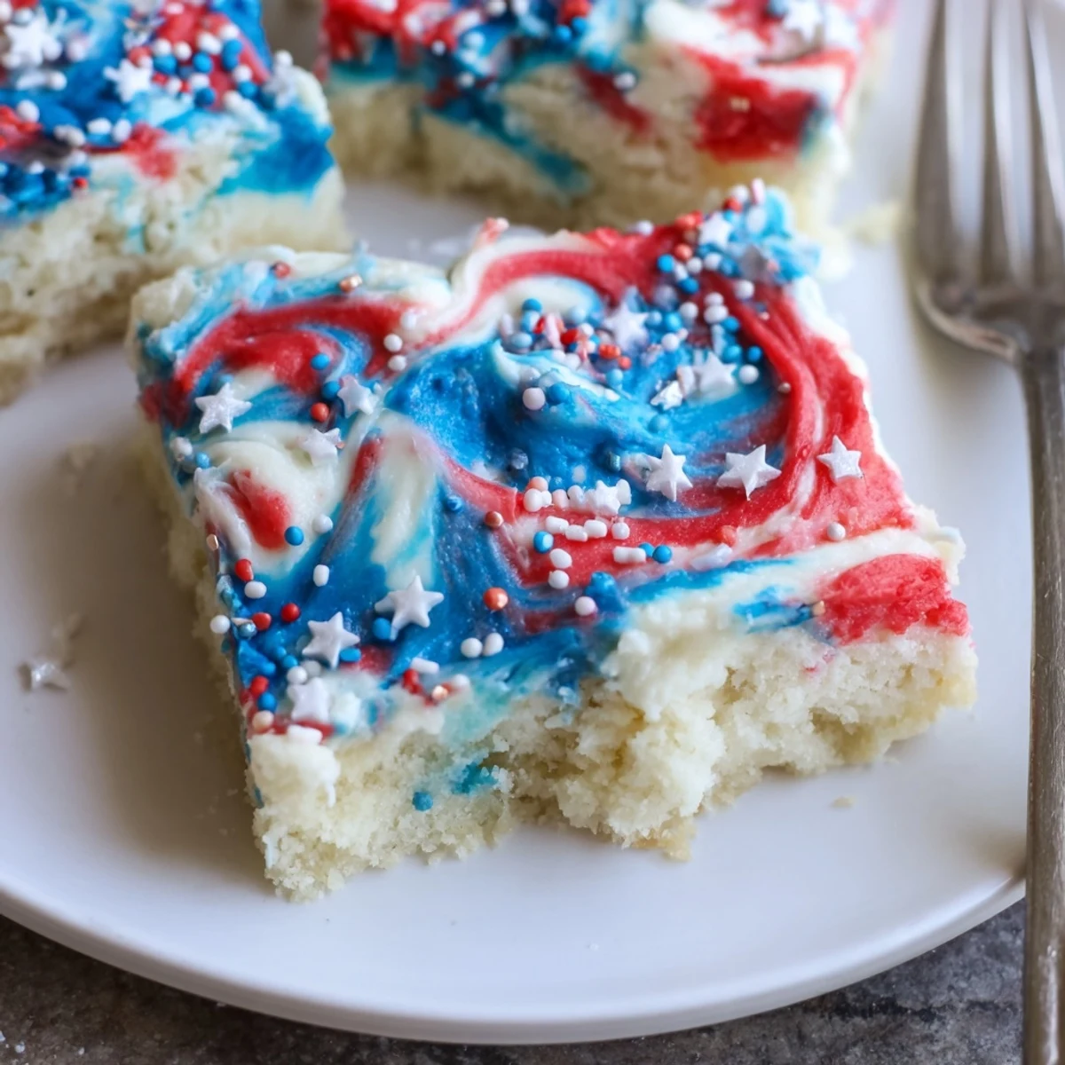 Festive Patriotic Sugar Cookie Bars 4th Of July Dessert Recipe topped with sprinkles