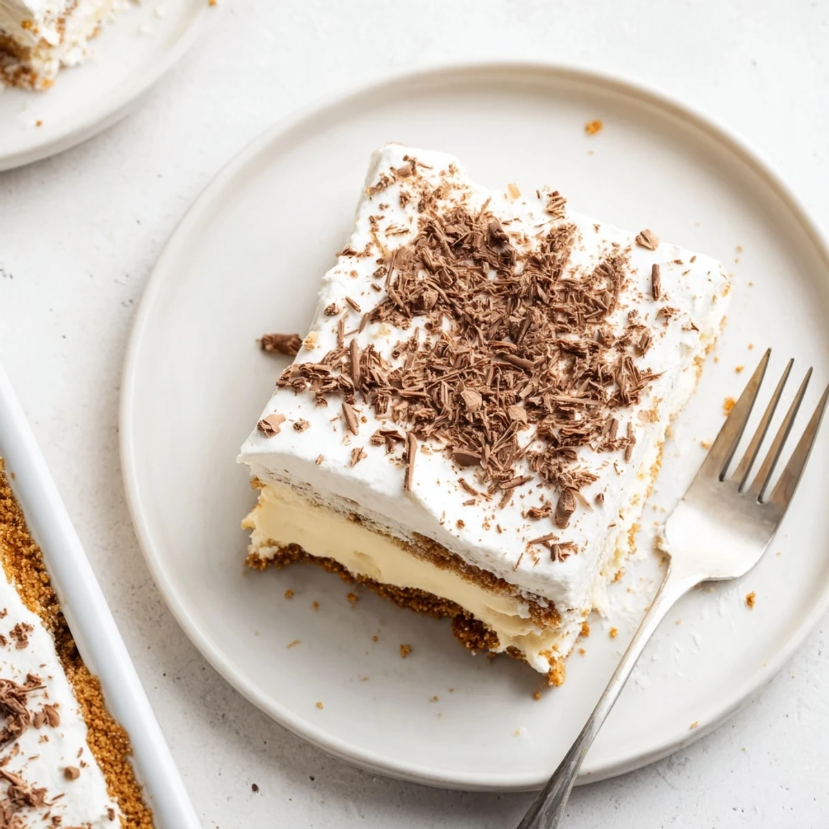 Slice of No Bake Layered Dessert showing soft whipped cream, silky pudding layers