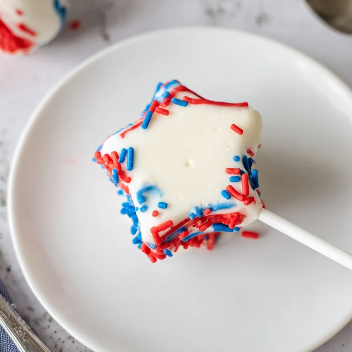 Chilled Fourth Of July Star Cheesecake Pops on sticks, perfect for summer picnics