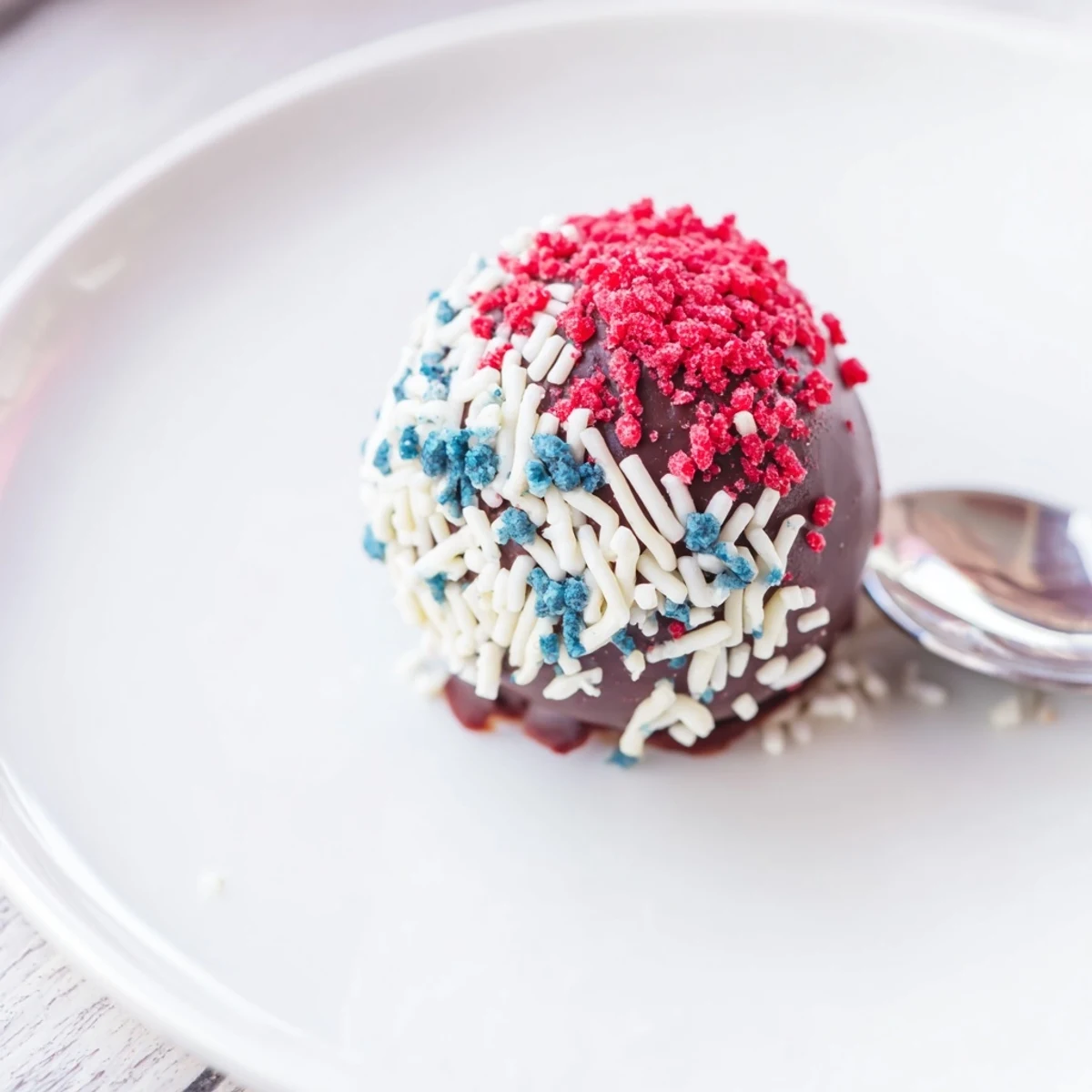Hand-rolled Fourth of July truffles chilled and speckled with freeze-dried berries