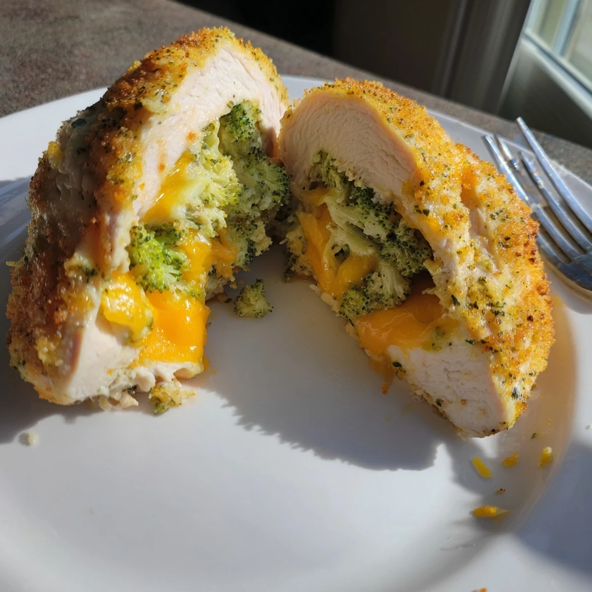 Sliced Broccoli Cheese Stuffed Chicken Breast with bubbling cheddar and golden edges