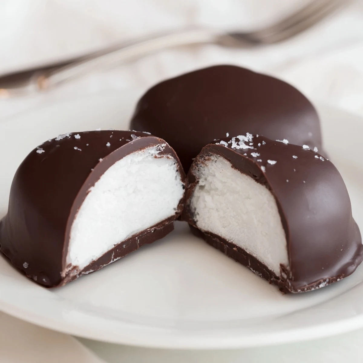 Peppermint Patties: glossy dark chocolate shells encasing cool mint filling, on parchment.