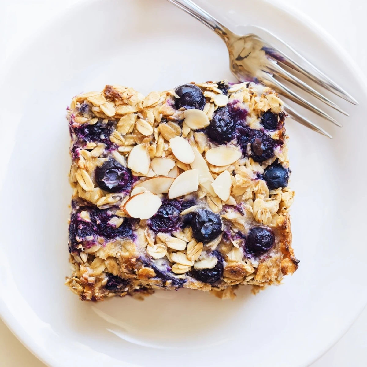 Warm high protein lemon blueberry breakfast bake dusted with chia seeds and almonds