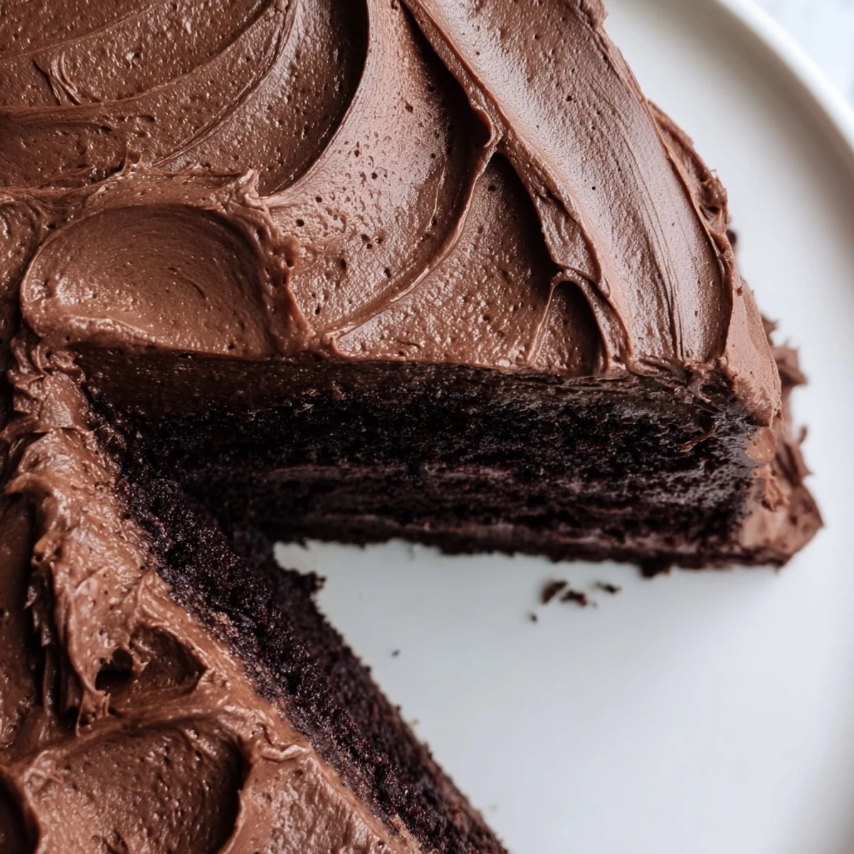 Slice of Matilda chocolate cake revealing tender crumb under silky chocolate frosting