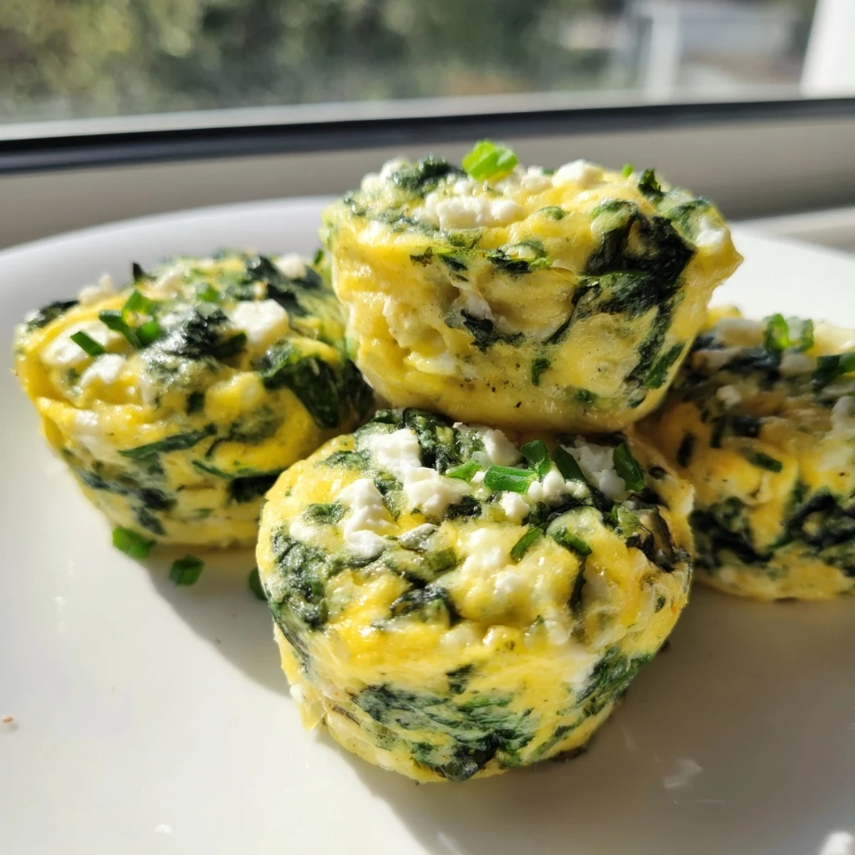 Golden Savory Spinach Feta Egg Bakes with visible green spinach pieces and white feta crumbles