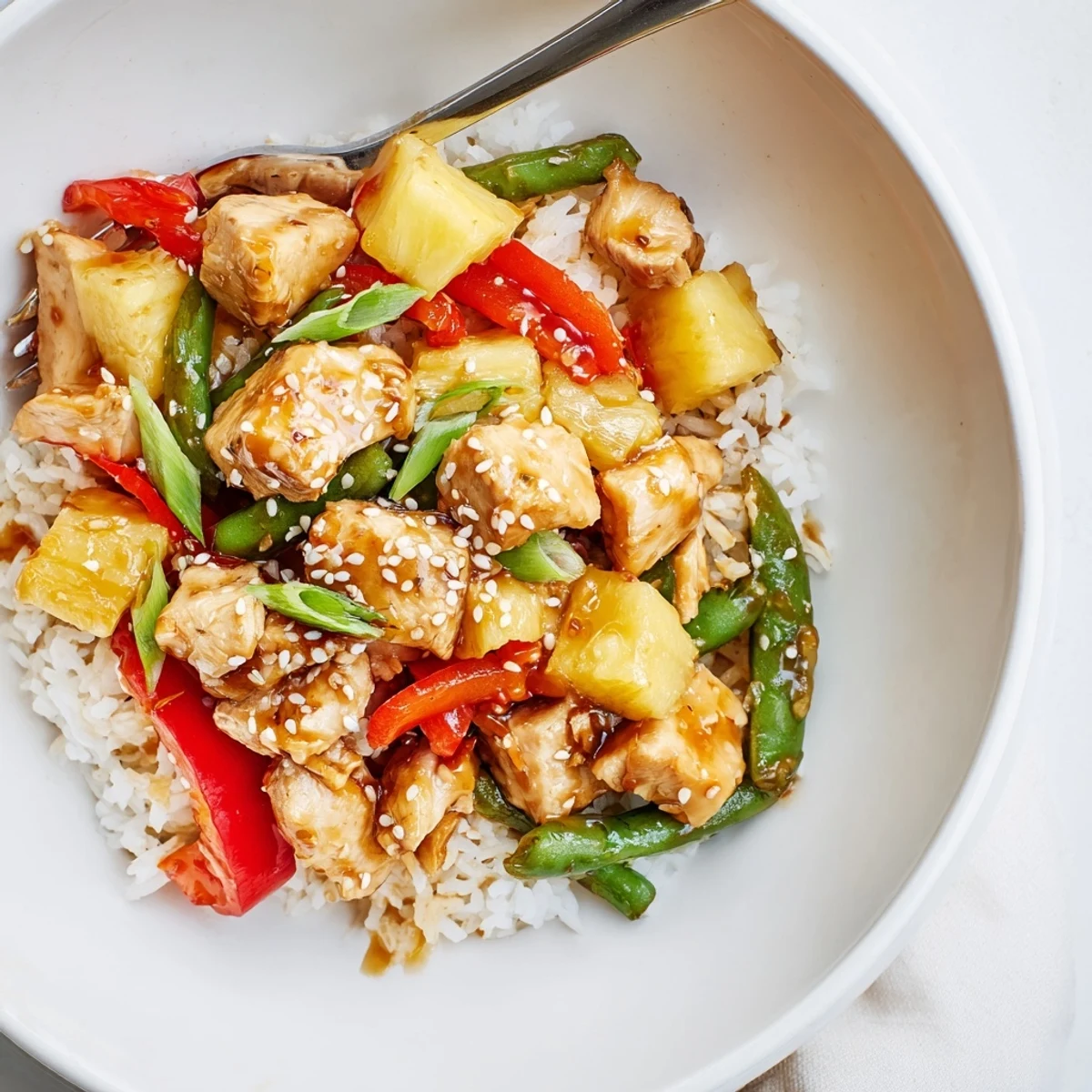 Colorful Pineapple Chicken And Rice tossed with caramelized pineapple and crisp sugar snap peas