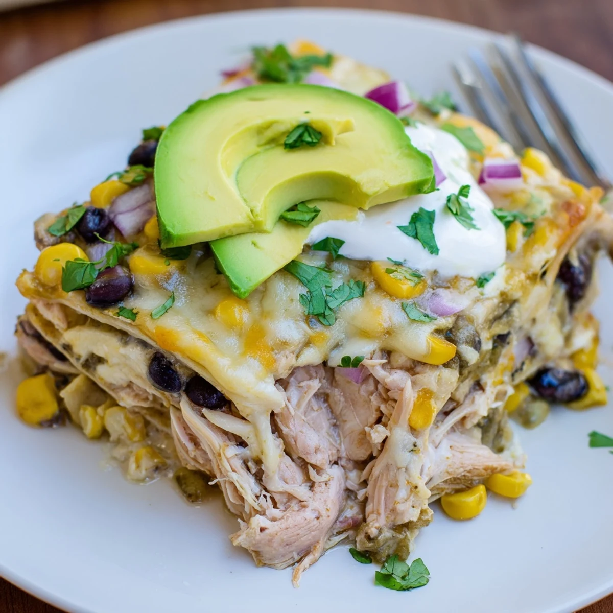 Slice of Salsa Verde Chicken Casserole on plate, tender chicken, zesty aroma