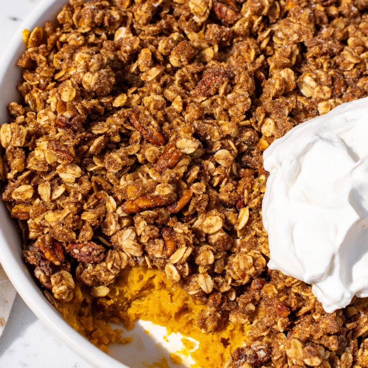Creamy spiced pumpkin pie crisp with golden oat topping fresh from oven