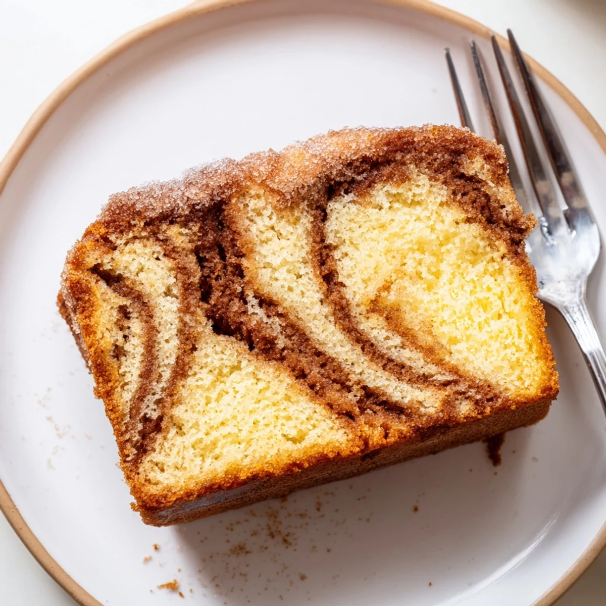 Warm cinnamon donut loaf sliced thick showing a golden cinnamon sugar crust